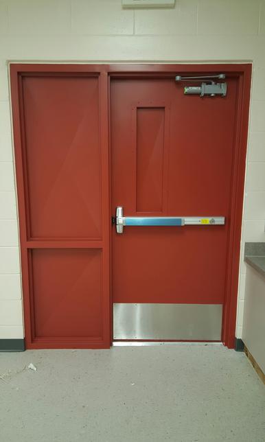Red hollow metal fire door with exit device